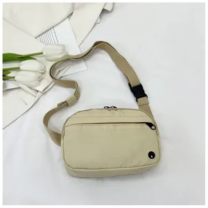 Beige waterproof nylon crossbody phone bag lightweight casual canvas shoulder sling bag.