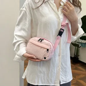 Pink nylon crossbody bag, lightweight daily shoulder phone bag with zipper and adjustable strap.
