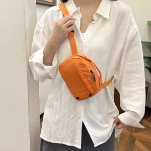 Casual orange nylon crossbody bag, lightweight sling phone bag for daily travel and outdoor use.