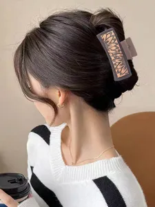 Retro PU hair claw clip featuring elegant sunflower engraving for women, chic back head styling.