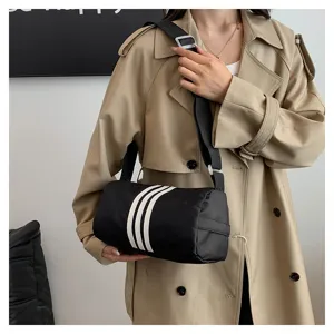 Nylon cylindrical shoulder bag with contrasting three stripes for daily casual use.
