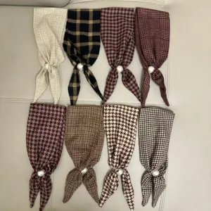 Detailed view of elegant plaid small silk scarves with pearl decoration for daily wear.