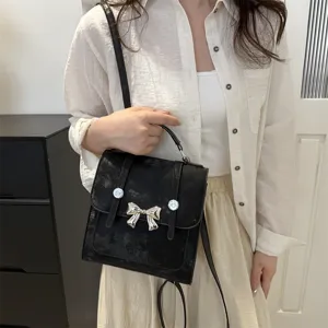 Black women handbag casual crossbody backpack with metallic bow design stylish daily use