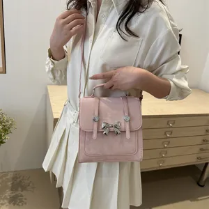 Korean style pink shoulder bag with metal bow design, casual sweet crossbody square handbag.