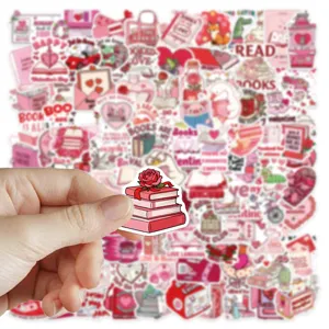 Close-up detail of pink bookish motivational stickers for laptop and phone case decoration.