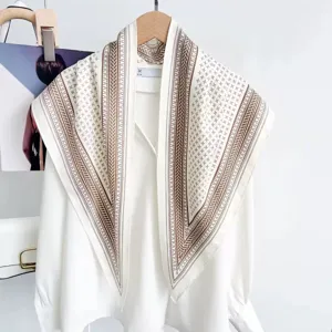 Close-up detail of the retro geometric patterned triangle scarf draped on a white shirt.