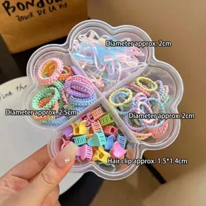 Conjunto de mini coleteros y pequenas pinzas de pelo para ninos en caja de almacenamiento.