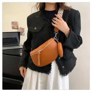 Stylish women chest bag crossbody saddle bag with wide patterned strap and small coin purse.