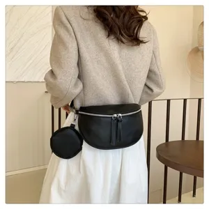 Close up details of stylish black leather saddle bag with small round coin purse for women.