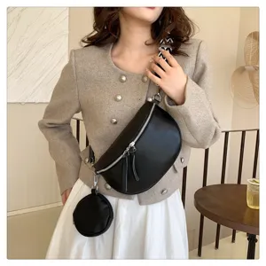 Black leather chest bag for women, trendy saddle crossbody bag with small coin purse, chic style.