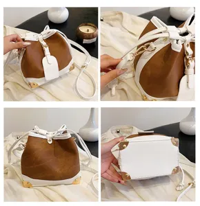 Detailansicht der zweifarbigen Beuteltasche mit Kordelzug und metallischen Ecken.