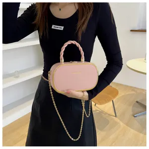 Sac à main boîte rose pour femme, sac bandoulière élégant avec poignée tressée et chaîne dorée.