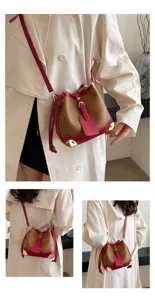 Modische braune und rote Eimertasche mit Metallecken für den herbstlichen Pendlerlook.
