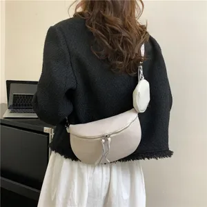 Stylish women's crescent crossbody bag in beige leather with small coin purse and zipper.