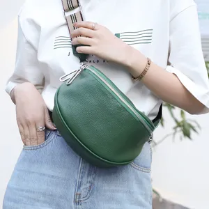 Green genuine cowhide leather saddle bag for women, stylish crossbody chest bag with wide strap.