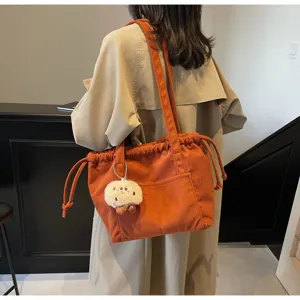 Corduroy tote bag for women, large capacity shoulder bag, casual commuting handbag with charm.
