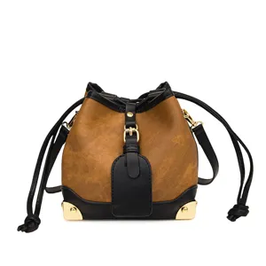 Modische braune Damen Eimer Tasche mit schwarzem Besatz und goldener Hardware Pendeln.