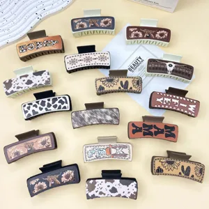 Western style leather hair claw clips with sunflower and cow skull design for women.