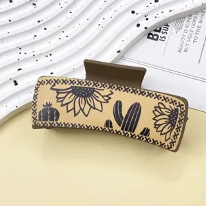 Detail view of the western cowboy style leather hair claw featuring sunflower and cactus print.