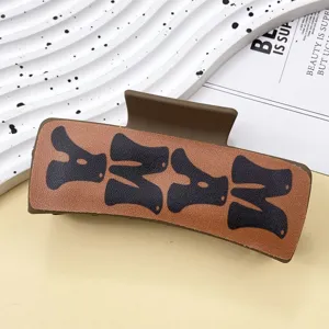 Brown leather hair claw clip for women, western style shark hair clamp for daily hairstyling.