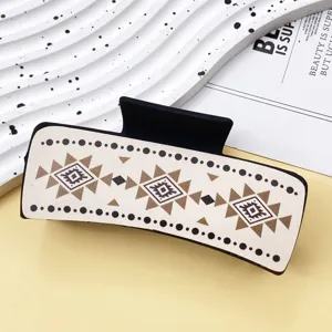 Geometric pattern leather hair claw clip detail close-up, stylish western style hair accessory.