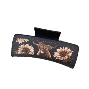 Western style leather hair claw clip with highland cow and sunflower design for women.