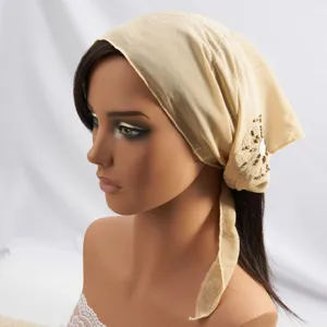 Detail view of the elegant beige triangle headscarf featuring delicate floral embroidery.