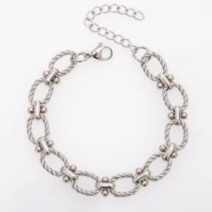 Close-up of twisted oval link stainless steel bracelet detail with secure lobster clasp.