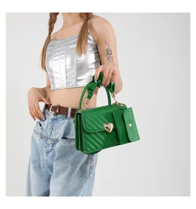 Green crossbody shoulder bag detail, stylish PU leather square purse with heart lock and side pouch.