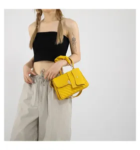 Yellow crossbody square bag detail view, quilted shoulder handbag with heart lock design.