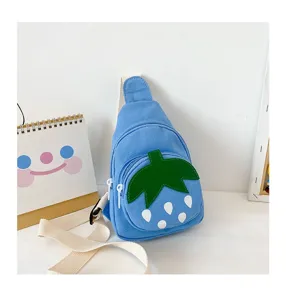 Cute children canvas sling bag detail showing blue fabric and green strawberry leaf design.