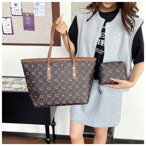 Detail shot of brown vintage monogram tote bag with matching small pouch for women daily use.