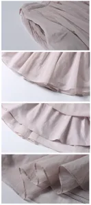 Nahaufnahme der hellrosa plissierten Chiffonrock-Details mit feiner Stofftextur und Saum.