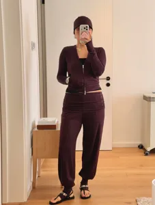 Detail view of the purple yoga outfit showcasing the stylish gathered waist and stirrup pants.