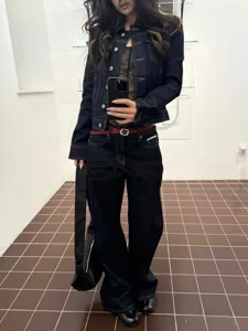 Dark denim jacket and jeans set, vintage style slim fit women outfit detail view.