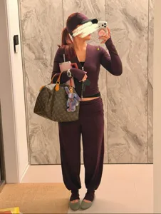 Womens stylish yoga activewear set with zip top and comfortable stirrup pants for fitness.