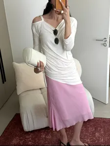 Pink bias cut midi mermaid skirt detail showing elegant drape and soft fabric texture.