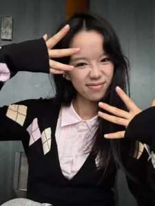 Chic black argyle knit cardigan paired with a sweet pink lapel shirt for women, stylish and cozy.