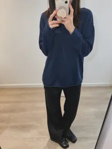 Casual loose-fit long sleeve blue knit pullover sweater detail view showcasing texture.