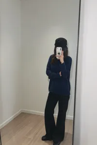 Detail view of casual loose-fit long sleeve knit top in deep blue, soft fabric style.
