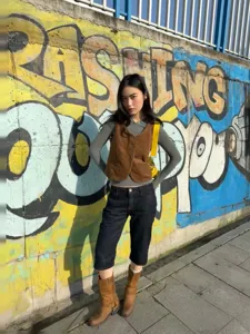 Slim fit cropped raw denim jeans for women featuring contrast red stitching details.