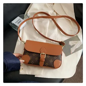 Detailed view of brown monogram crossbody bag with flap and metal buckle, stylish accessory.