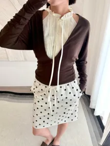 Stylish women's layered long sleeve top with white ruffled collar shirt and polka dot skirt for spring.