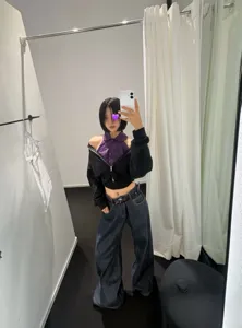 Women stylish purple halter shirt layered with black cropped jacket and baggy jeans