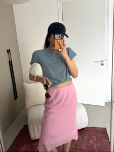 Detail presentation of the elegant pink linen-blend bias-cut midi mermaid skirt.