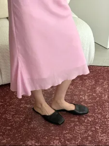 Pink linen blend fishtail skirt hem detail, elegant asymmetric drape for women style.