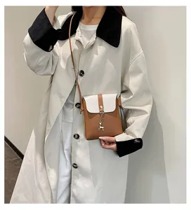 Women mini crossbody phone bag detail, stylish contrast color leather shoulder pouch.