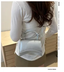 Minimalist silver women handbag detail, stylish commuter shoulder crossbody bag design.