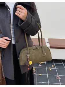 Detail view of the retro olive green shoulder bag showing fine stitching and metal zipper.