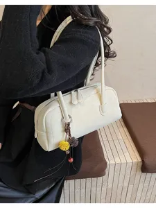 White PU leather shoulder pillow bag with double handles and cute pendant for women commuting.